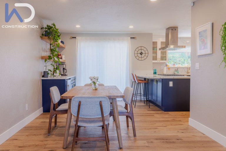 Full house renovation in Concord — refreshed open living area with light wood flooring and recessed lighting by We Do Construction