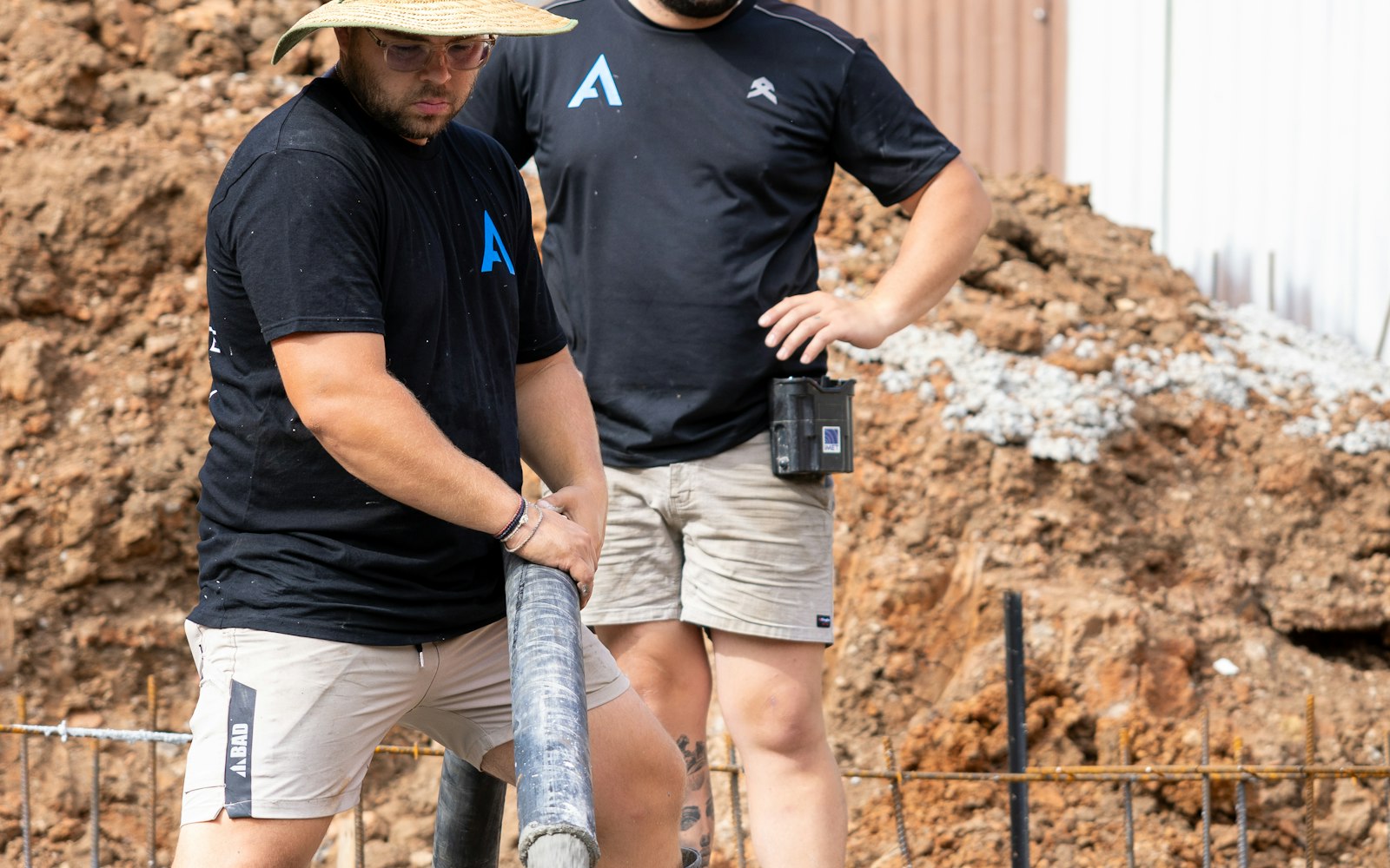 Construction workers finishing a concrete building foundation