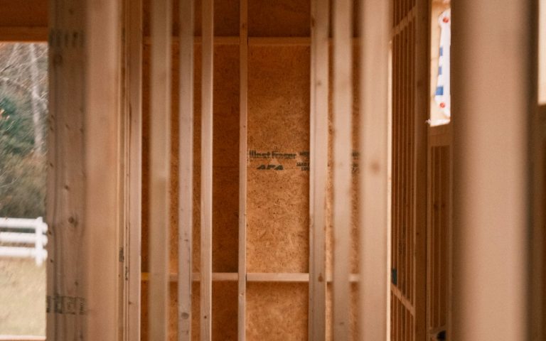 Room mid-renovation with exposed wood stud framing
