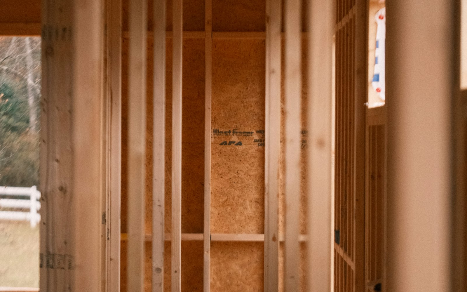 Room mid-renovation with exposed wood stud framing