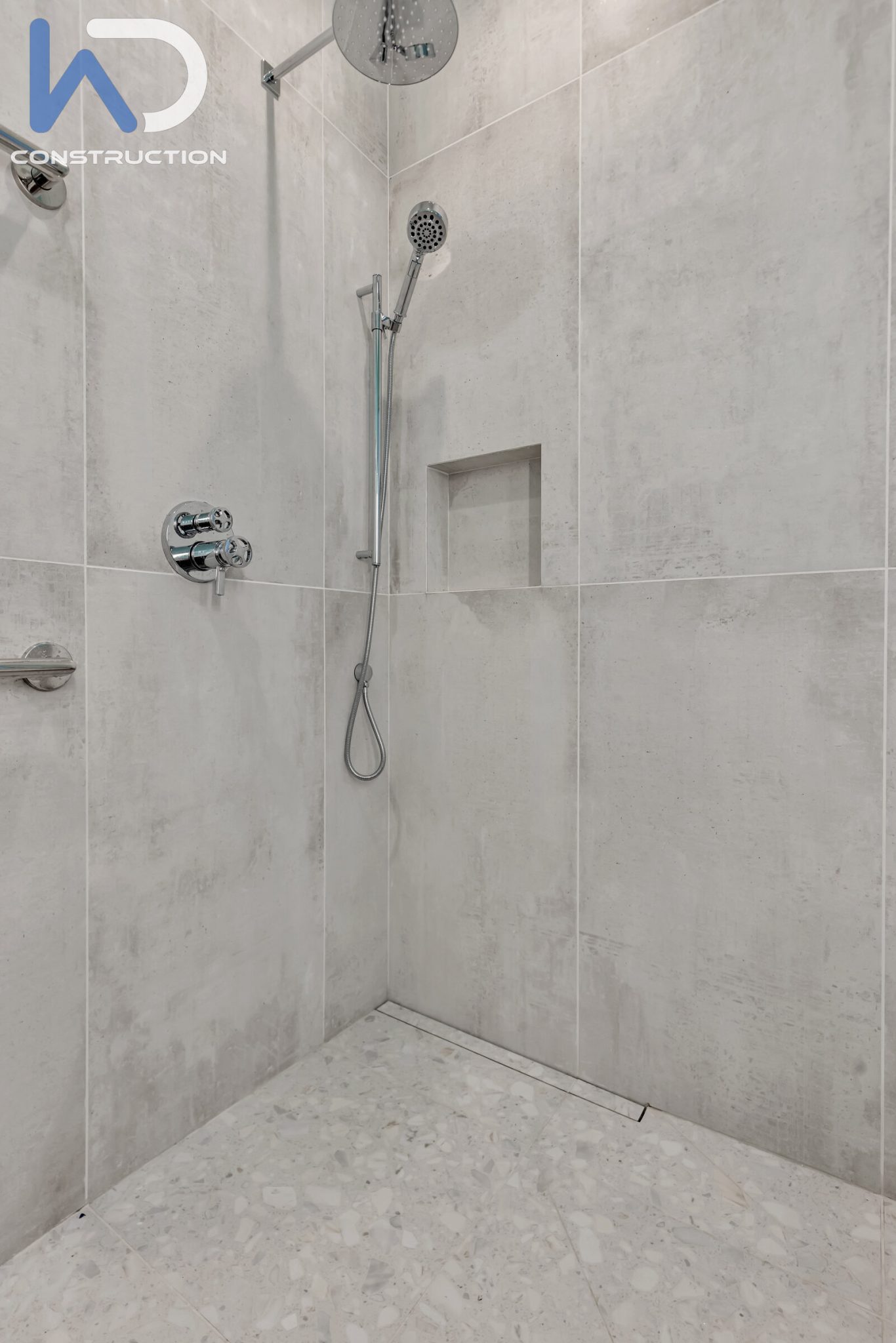 San Francisco bathroom remodel with a gray stone-look shower, a recessed niche, a glass enclosure and wall-mounted fixtures, Page Street, by WDC